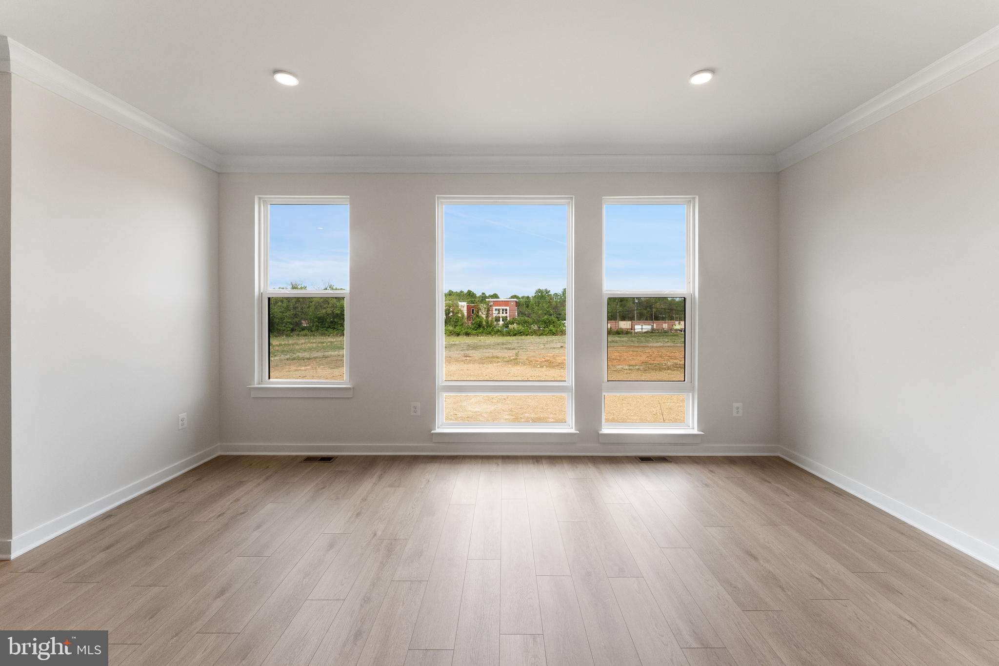 113 Summit Point Boulevard, Unit 19J Bowie, MD 20716 - Photo 28 of 38 an empty room with wooden floor and windows
