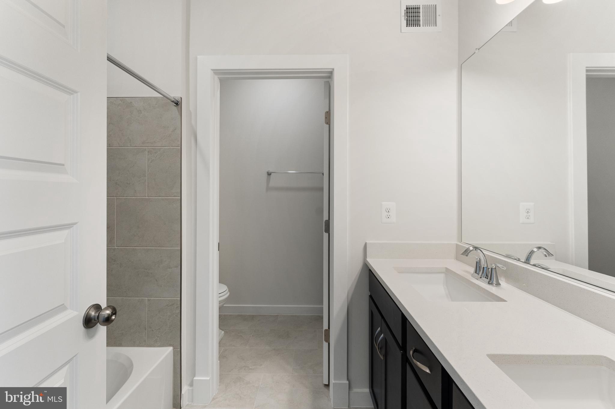 113 Summit Point Boulevard, Unit 19J Bowie, MD 20716 - Photo 30 of 38 a bathroom with a sink and a mirror