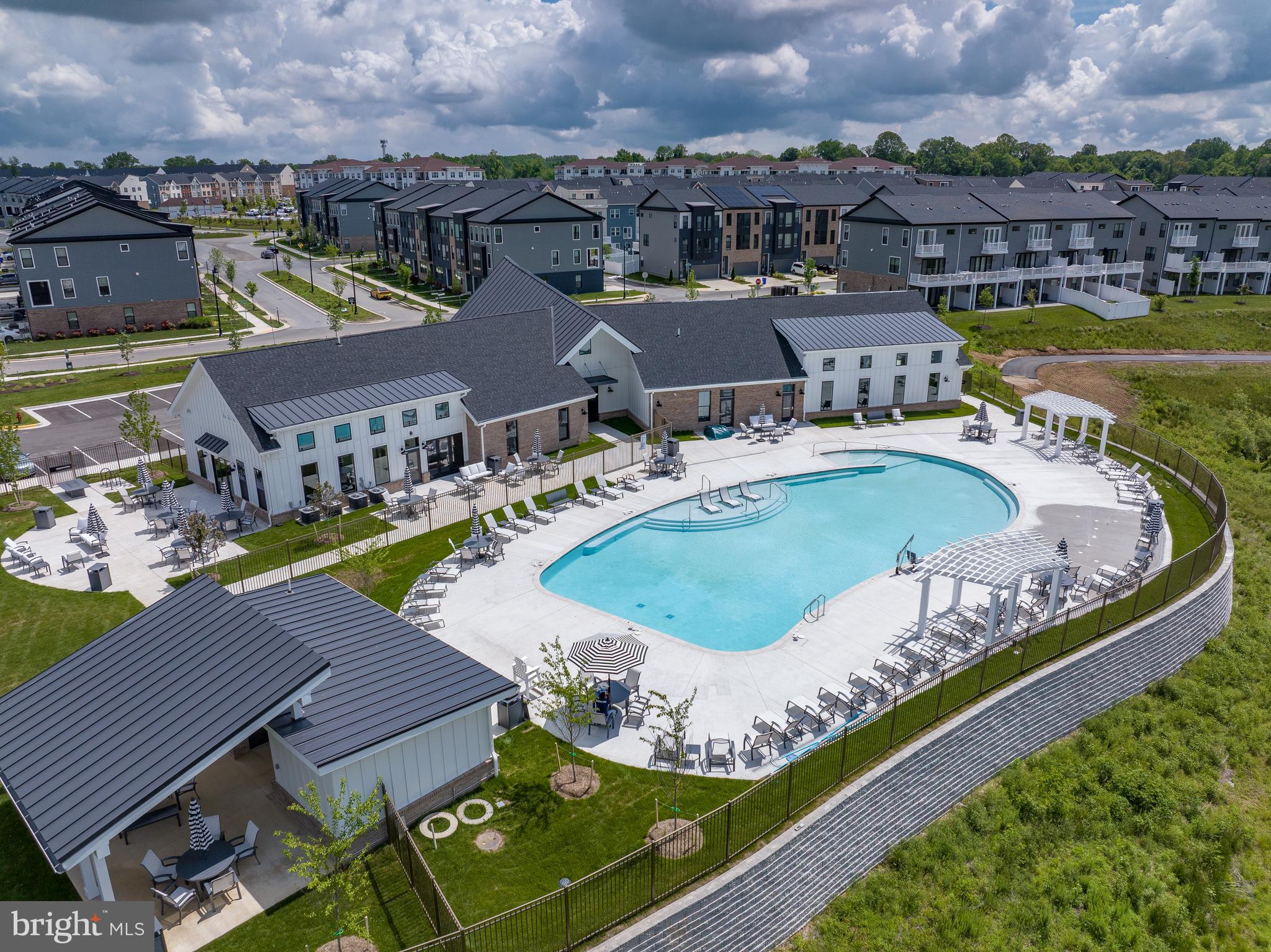 113 Summit Point Boulevard, Unit 19J Bowie, MD 20716 - Photo 37 of 38 an aerial view of a house with a swimming pool outdoor seating and yard