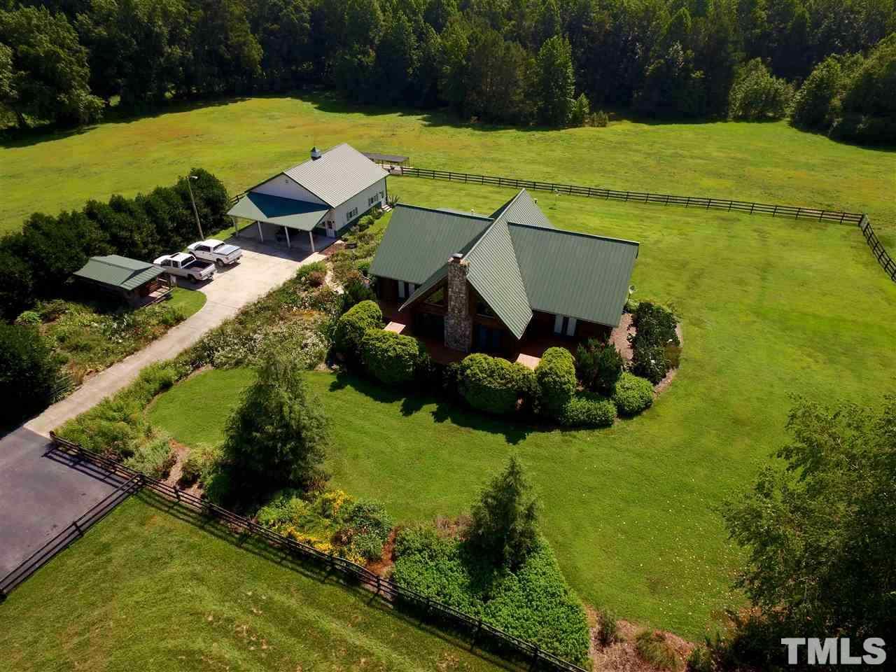 an aerial view of a house with pool yard and outdoor seating