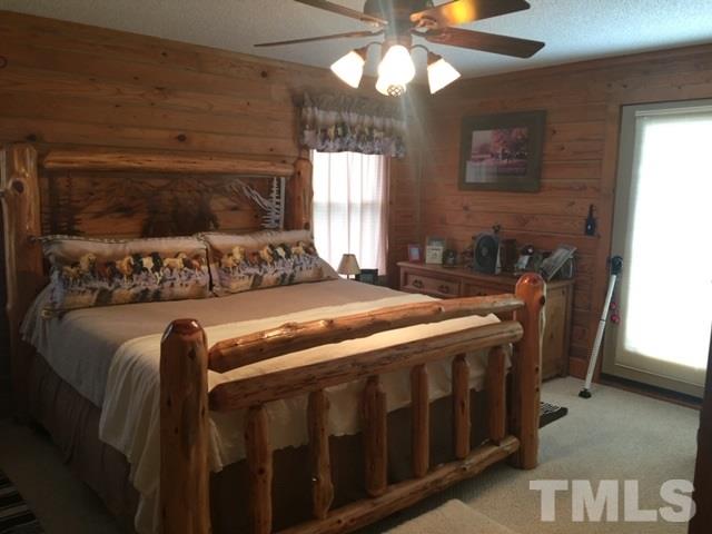 1001 Horse Creek Road Raleigh, NC 27603 - Photo 11 of 21 a bedroom with a bed and a chandelier
