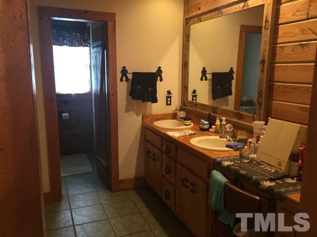 1001 Horse Creek Road Raleigh, NC 27603 - Photo 12 of 21 a bathroom with a double vanity sink and mirror