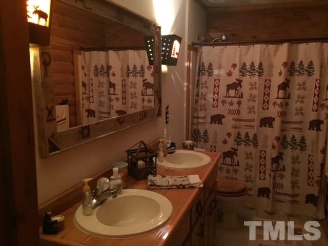 1001 Horse Creek Road Raleigh, NC 27603 - Photo 13 of 21 a bathroom with a sink toilet and shower