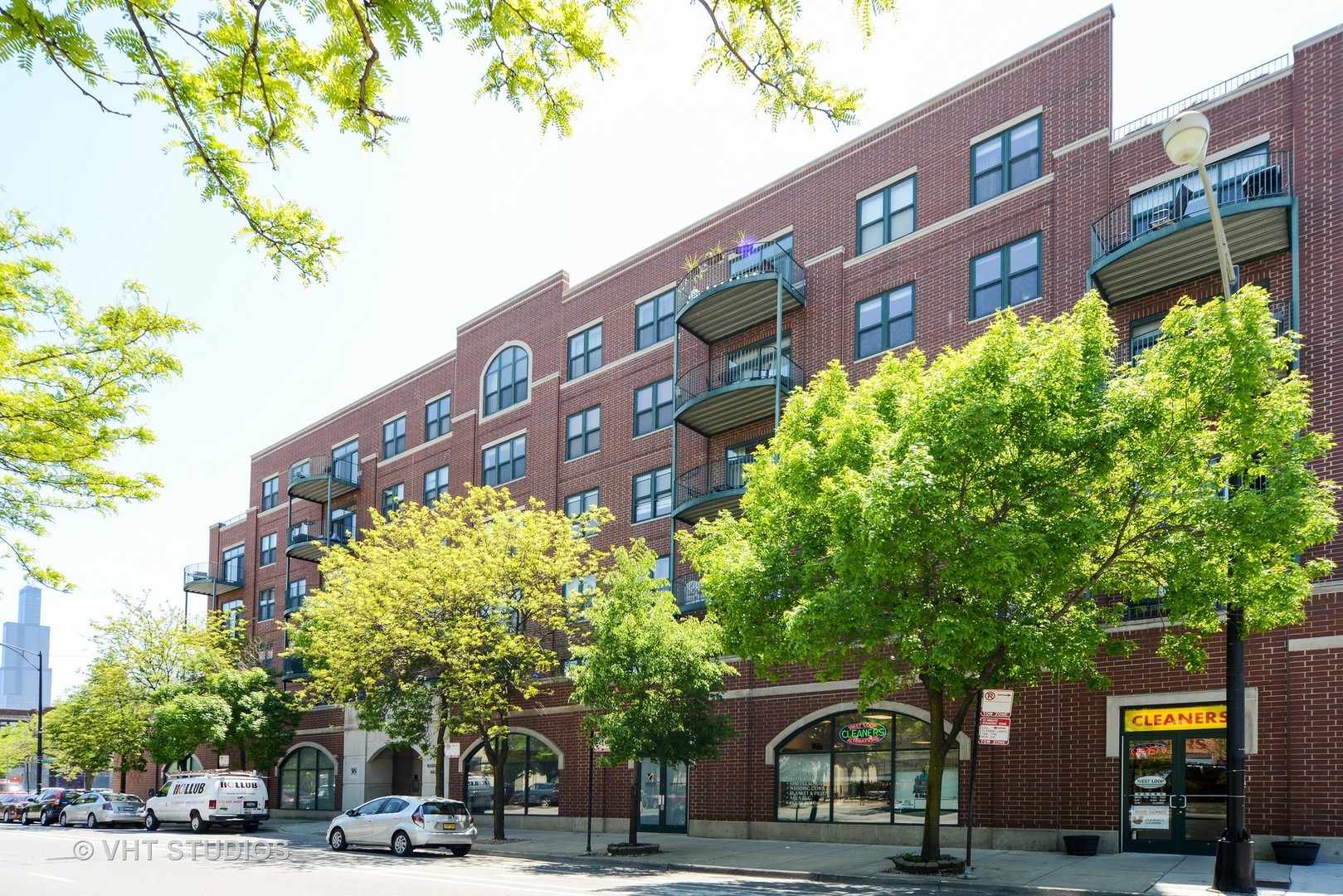 a front view of a building with trees