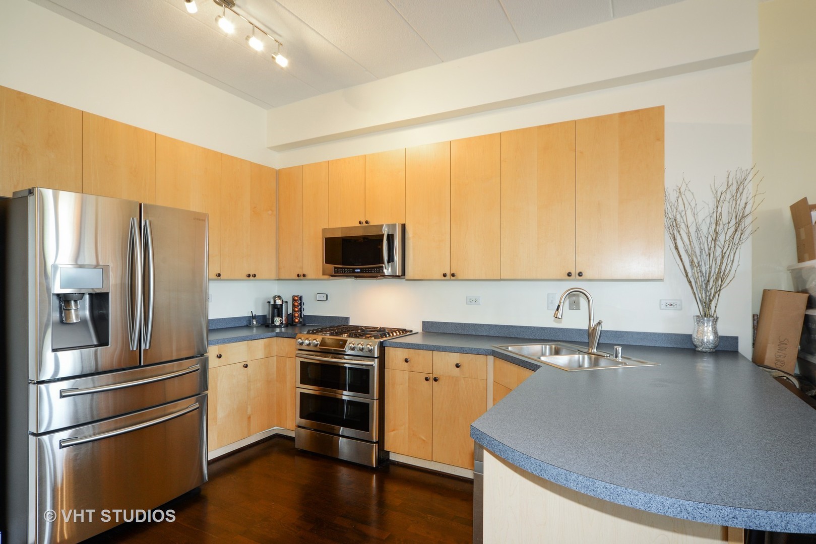 1301 West Washington Boulevard, Unit 404D Chicago, IL 60607 - Photo 4 of 11 a kitchen with a sink a refrigerator and a stove top oven