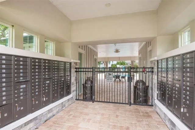a view of a house with many windows next to a yard