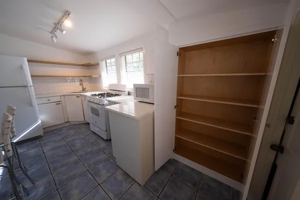 a kitchen with a stove refrigerator and cabinets