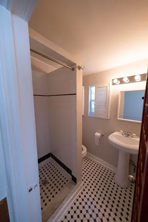 a bathroom with a sink toilet and shower