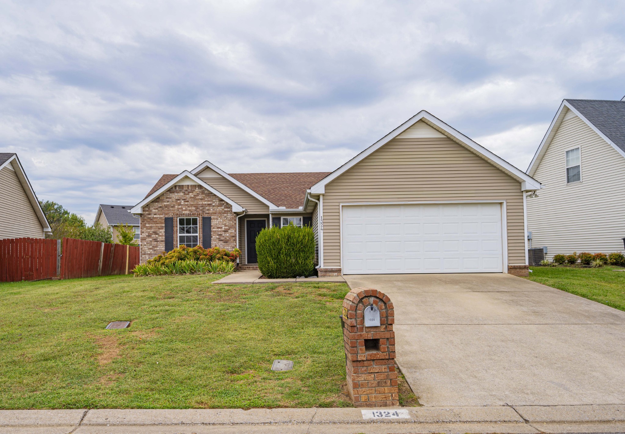 1324 Macduff Drive Murfreesboro, TN 37128 - Photo 1 of 35 a front view of a house with a yard and garage