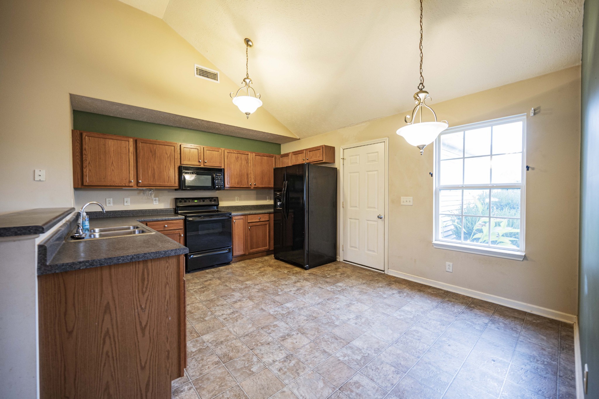 1324 Macduff Drive Murfreesboro, TN 37128 - Photo 20 of 35 a kitchen with a stove a sink and a refrigerator