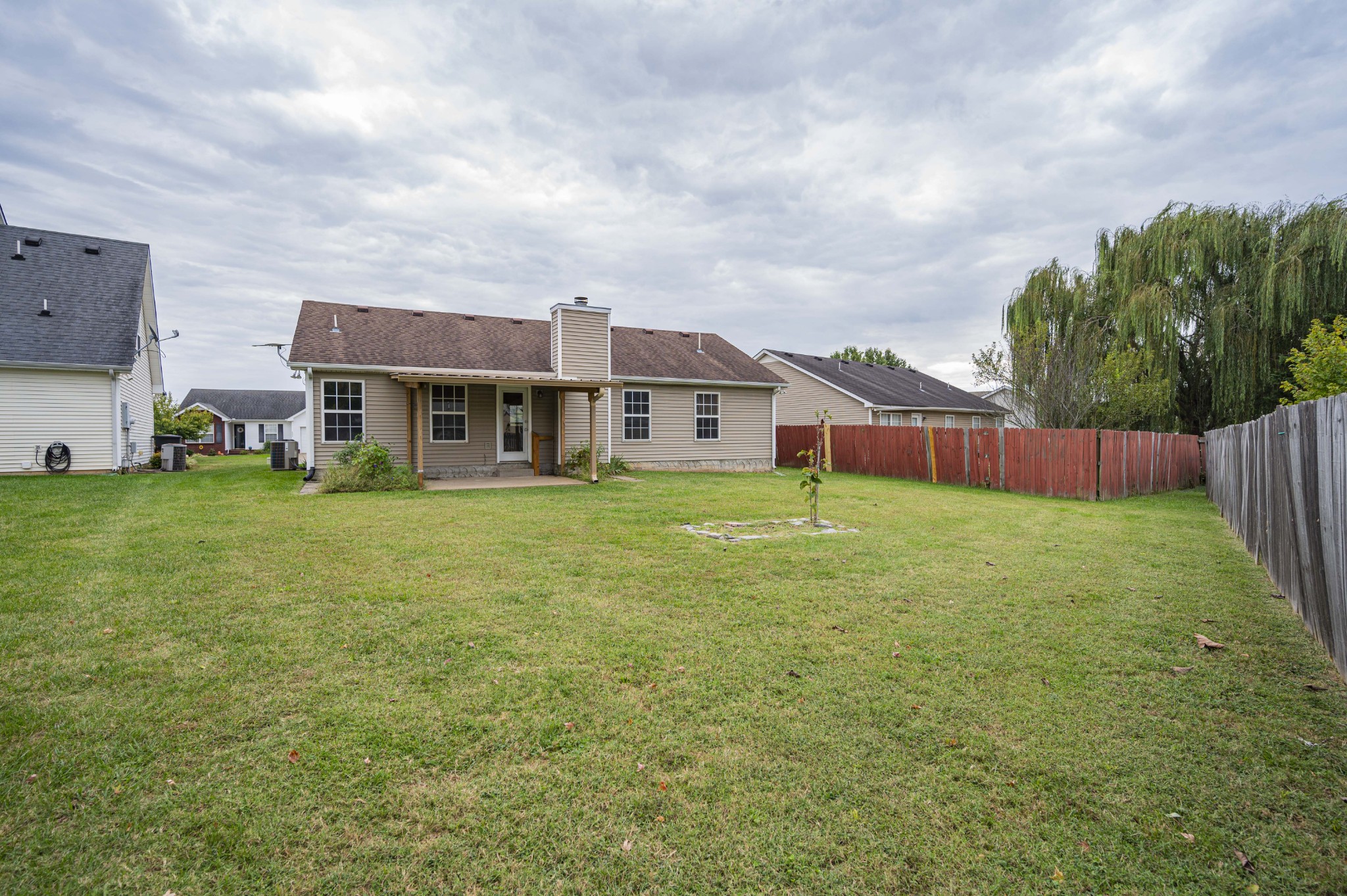 1324 Macduff Drive Murfreesboro, TN 37128 - Photo 9 of 35 a view of a house with a big yard and large trees