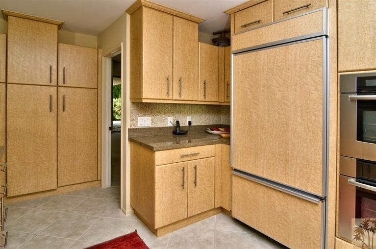 9 Seton Court Rancho Mirage, CA 92270 - Photo 13 of 42 a kitchen with a refrigerator and white cabinets