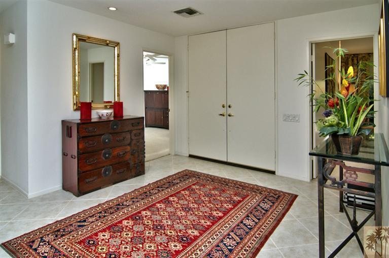 9 Seton Court Rancho Mirage, CA 92270 - Photo 16 of 42 a living room with furniture and a dresser