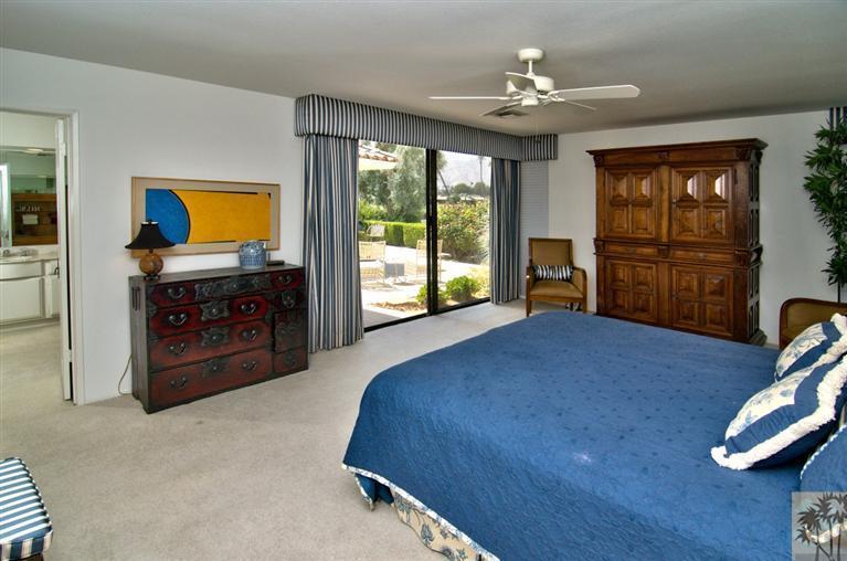 9 Seton Court Rancho Mirage, CA 92270 - Photo 18 of 42 a spacious bedroom with a bed and dresser with wooden floor