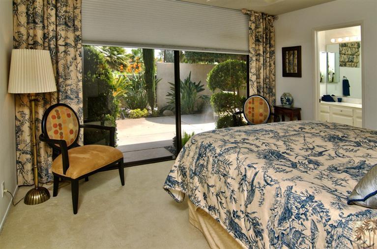 9 Seton Court Rancho Mirage, CA 92270 - Photo 21 of 42 a bedroom with a bed and a window
