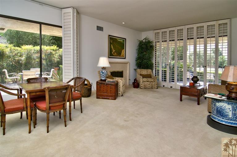 9 Seton Court Rancho Mirage, CA 92270 - Photo 9 of 42 a living room with furniture large window and a flat tv screen