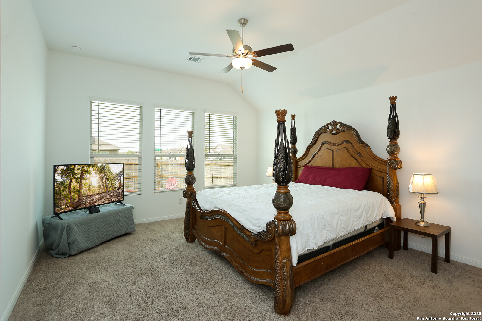5798 Luciano Ridge Seguin, TX 78155 - Photo 16 of 36 a bedroom with a bed and a flat screen tv
