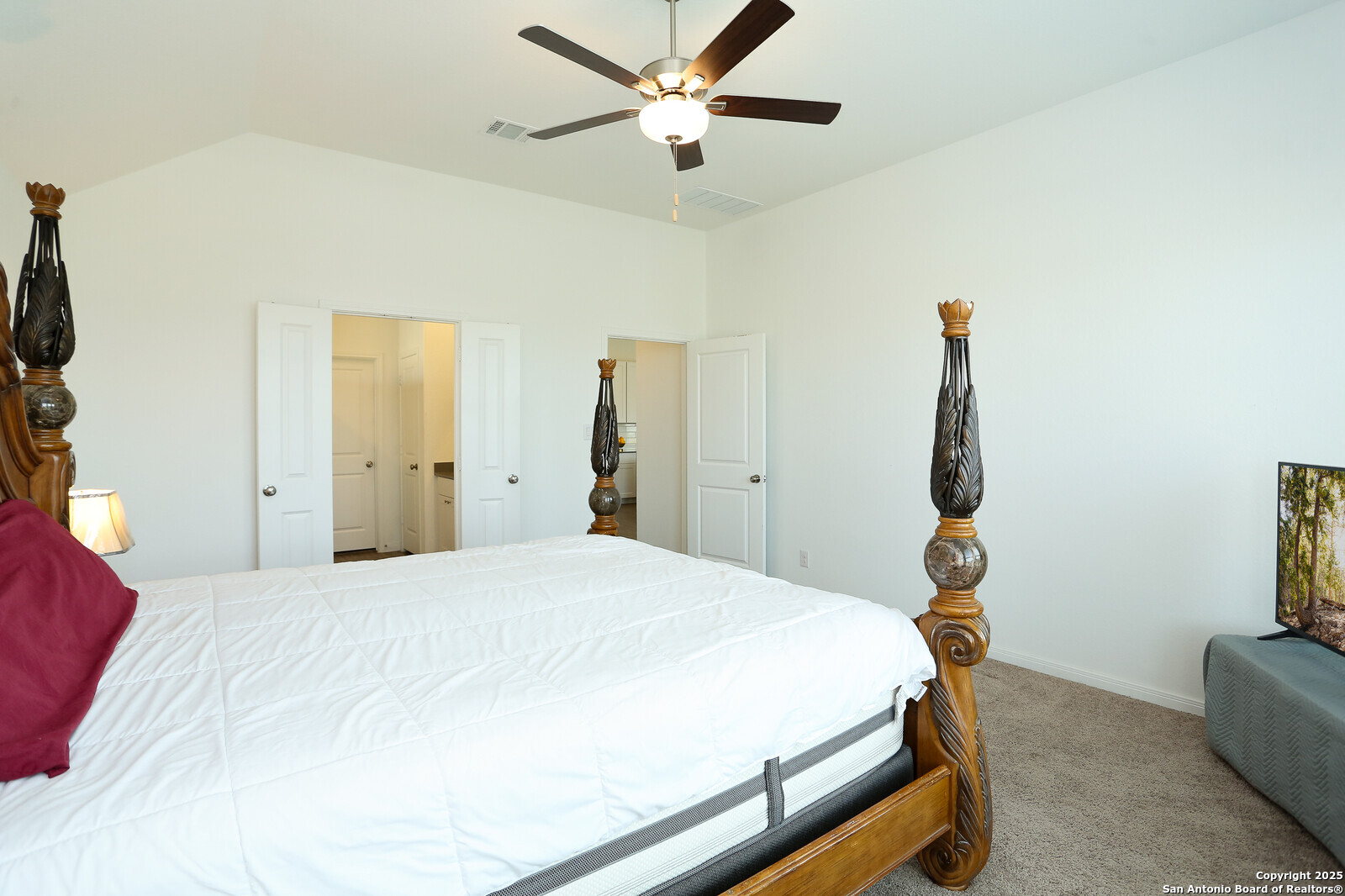 5798 Luciano Ridge Seguin, TX 78155 - Photo 17 of 36 a bedroom with a bed and a chandelier