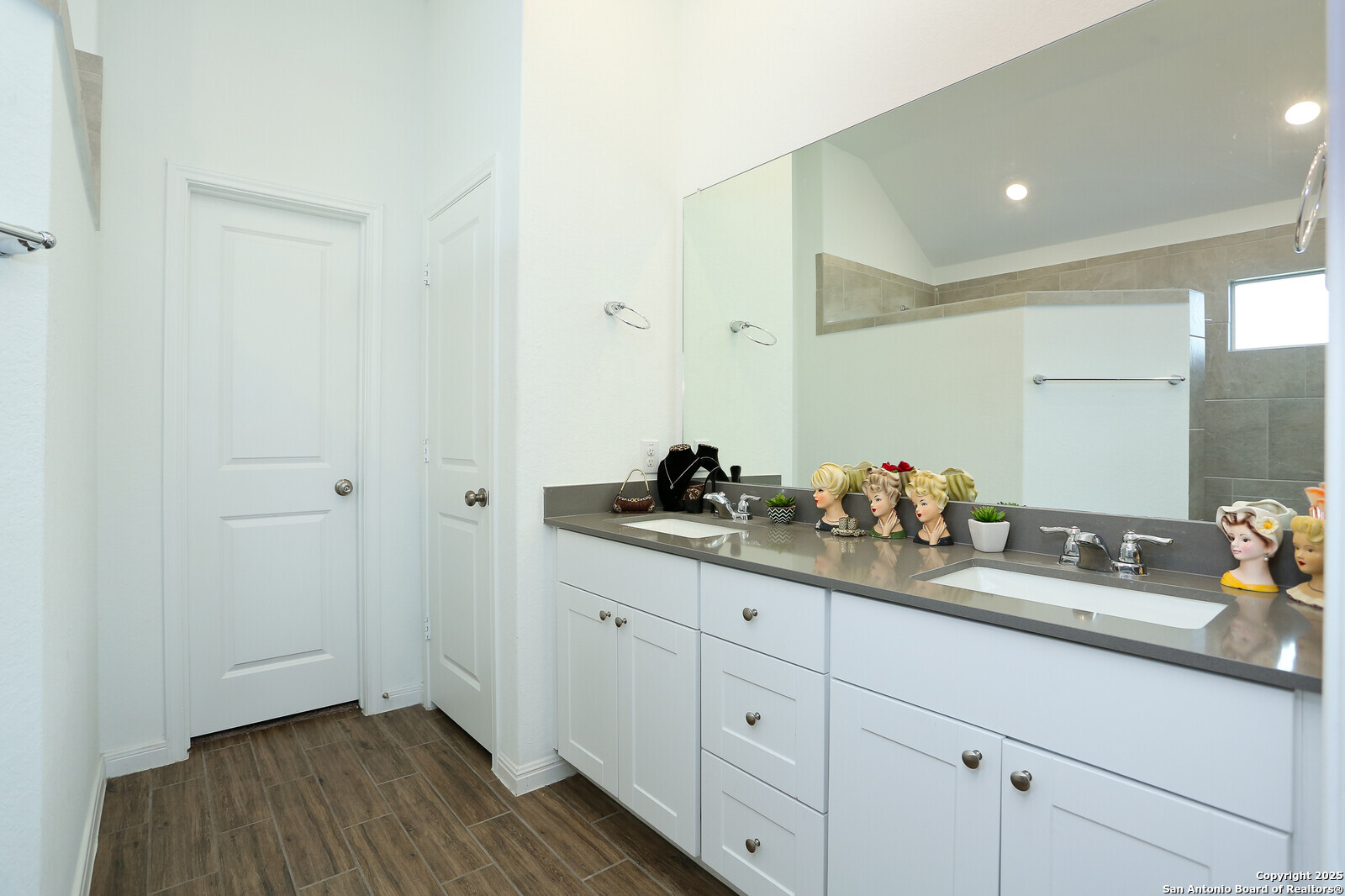 5798 Luciano Ridge Seguin, TX 78155 - Photo 18 of 36 a bathroom with a double vanity sink and a mirror