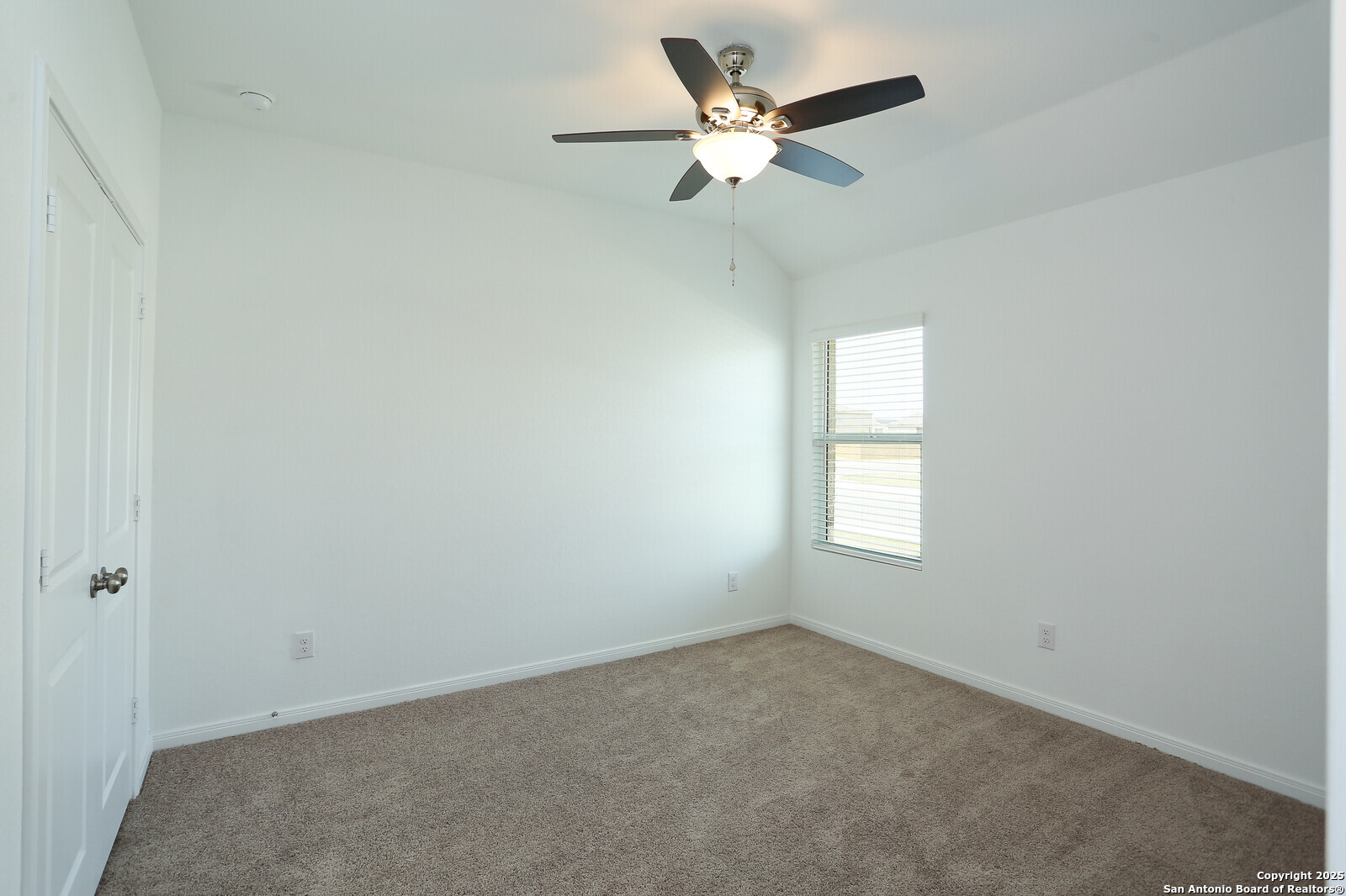 5798 Luciano Ridge Seguin, TX 78155 - Photo 21 of 36 an empty room with a window and a fan