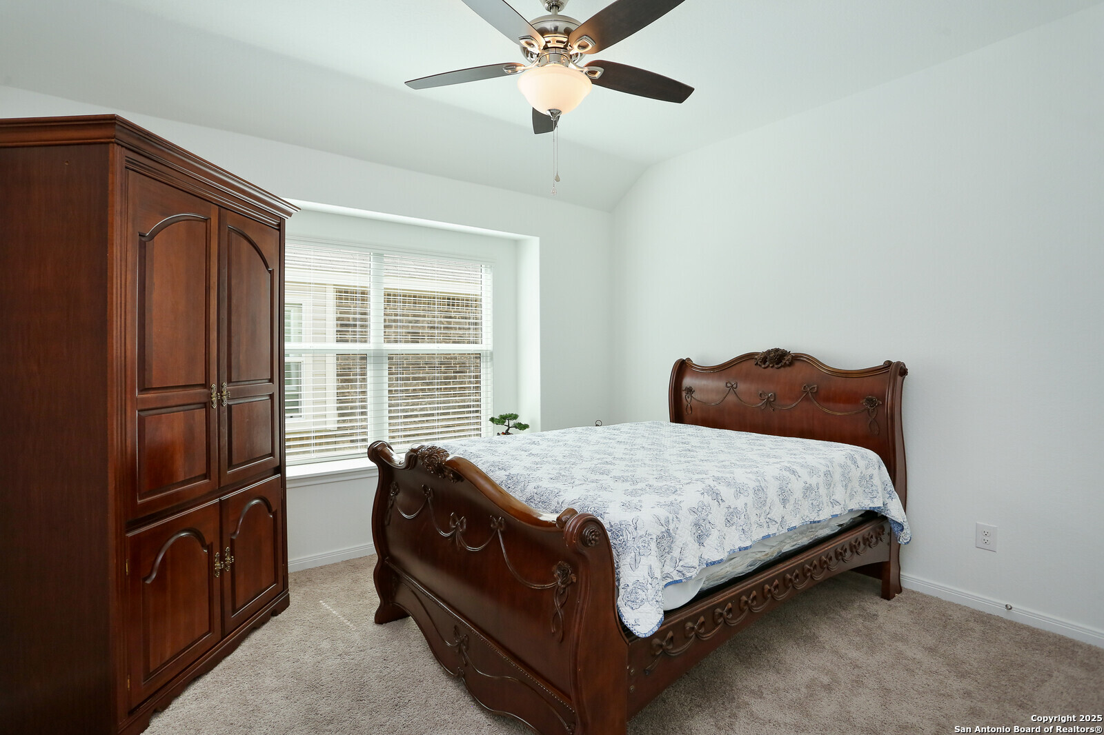 5798 Luciano Ridge Seguin, TX 78155 - Photo 24 of 36 a bed sitting in a bedroom next to a window