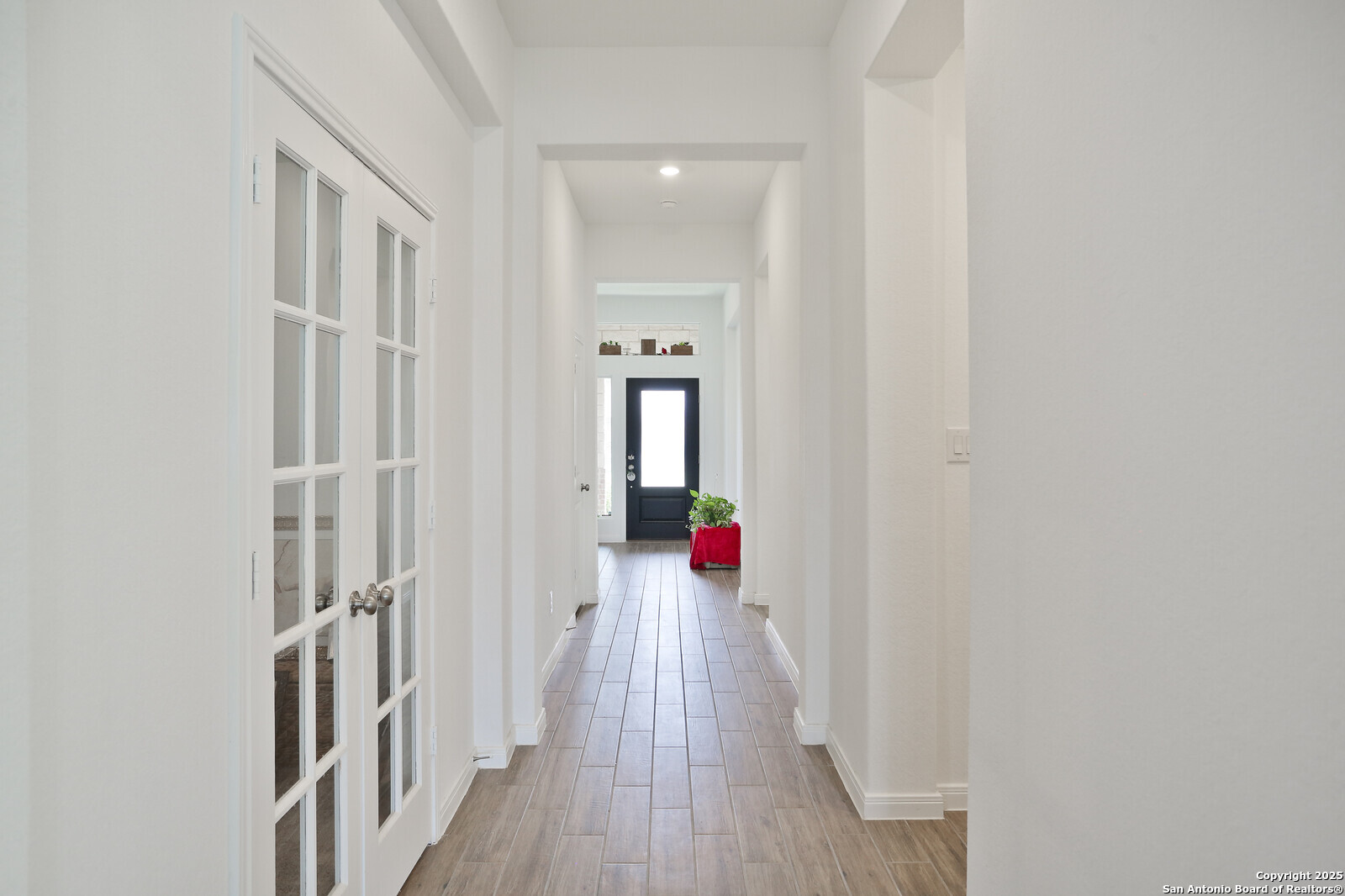 5798 Luciano Ridge Seguin, TX 78155 - Photo 7 of 36 a view of a hallway with wooden floor and staircase
