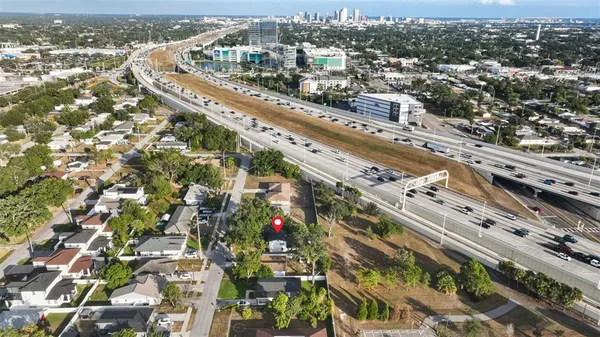 an aerial view of residential houses with city view