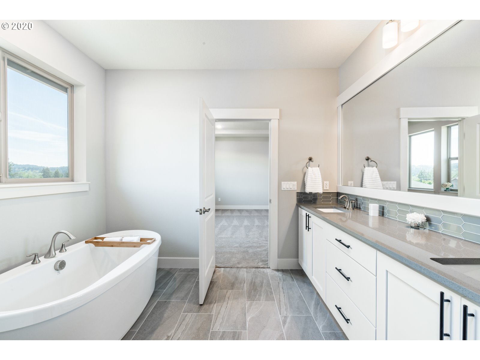 8807 North 5th Street, Unit LT52 Ridgefield, WA 98642 - Photo 22 of 31 a bathroom with a double vanity sink a mirror and a bathtub
