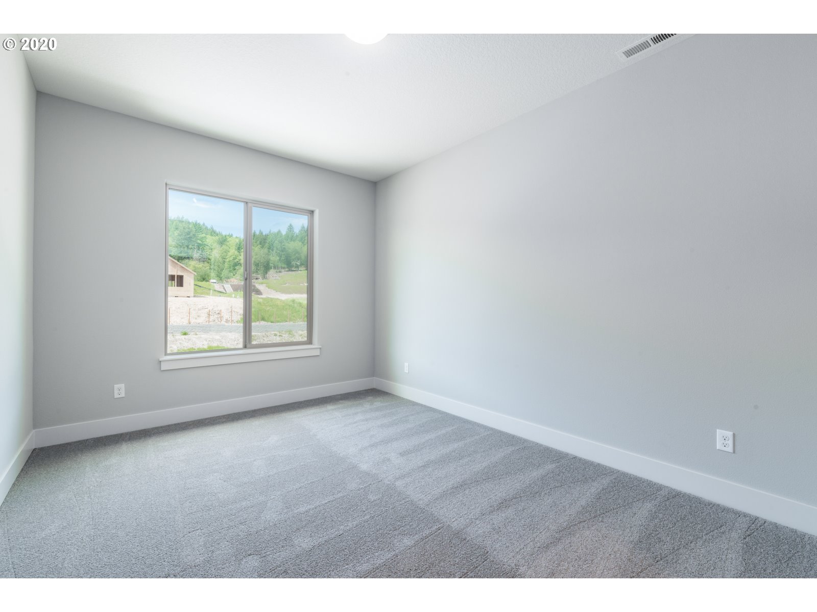 8807 North 5th Street, Unit LT52 Ridgefield, WA 98642 - Photo 25 of 31 a view of an empty room with wooden floor and a window