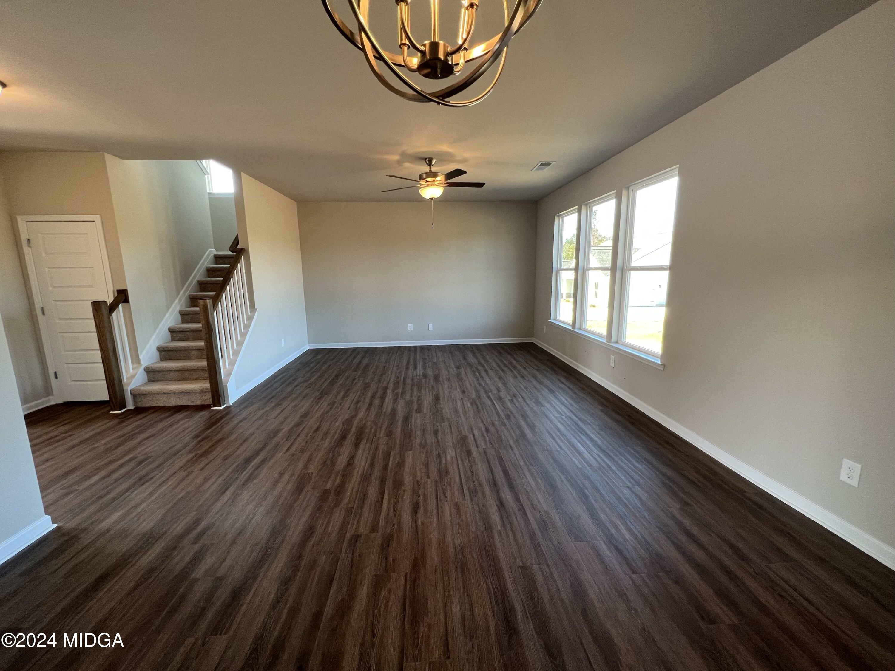 183 Sanders Road Macon, GA 31210 - Photo 12 of 44 an empty room with wooden floor and windows