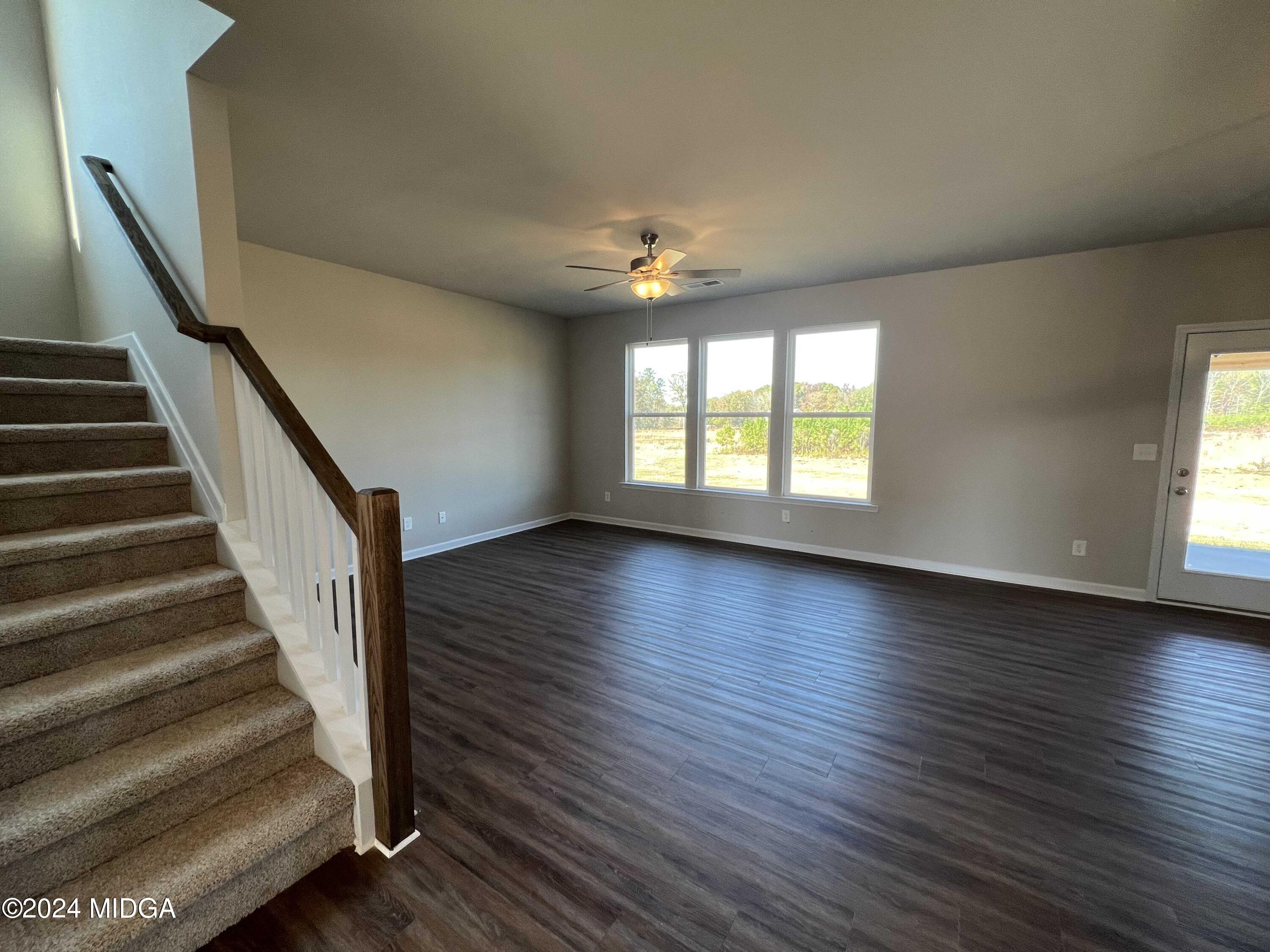 183 Sanders Road Macon, GA 31210 - Photo 16 of 44 a view of an empty room with wooden floor and a window