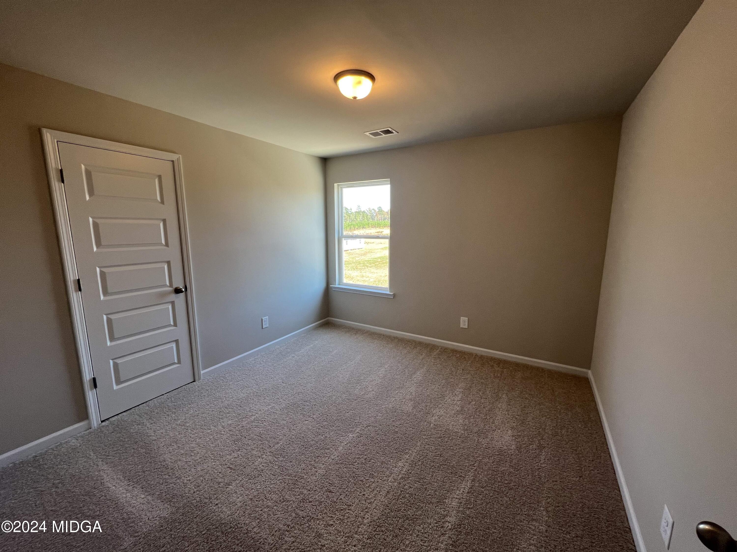 183 Sanders Road Macon, GA 31210 - Photo 21 of 44 an empty room with windows and closet