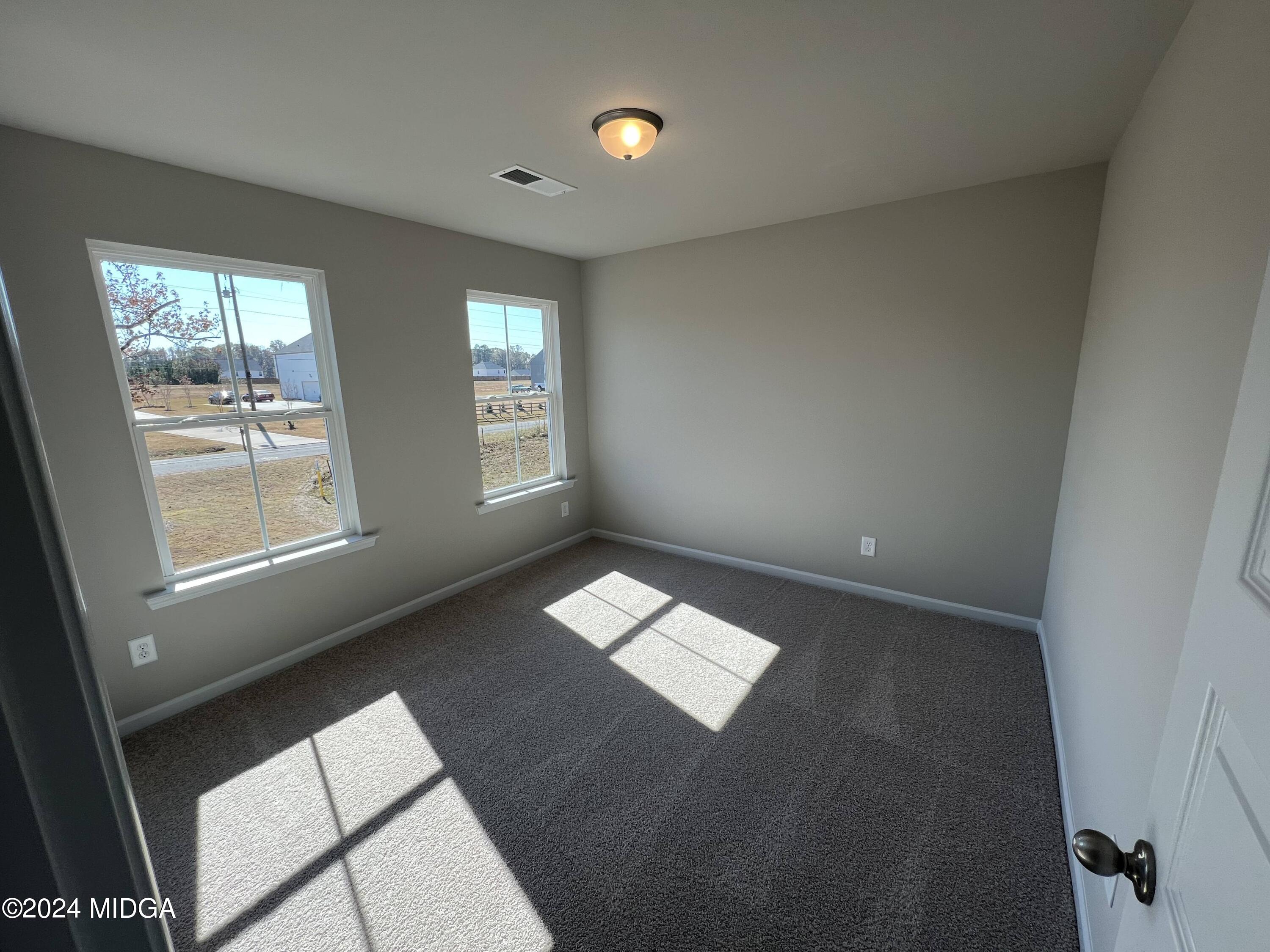 183 Sanders Road Macon, GA 31210 - Photo 22 of 44 a view of an empty room and window