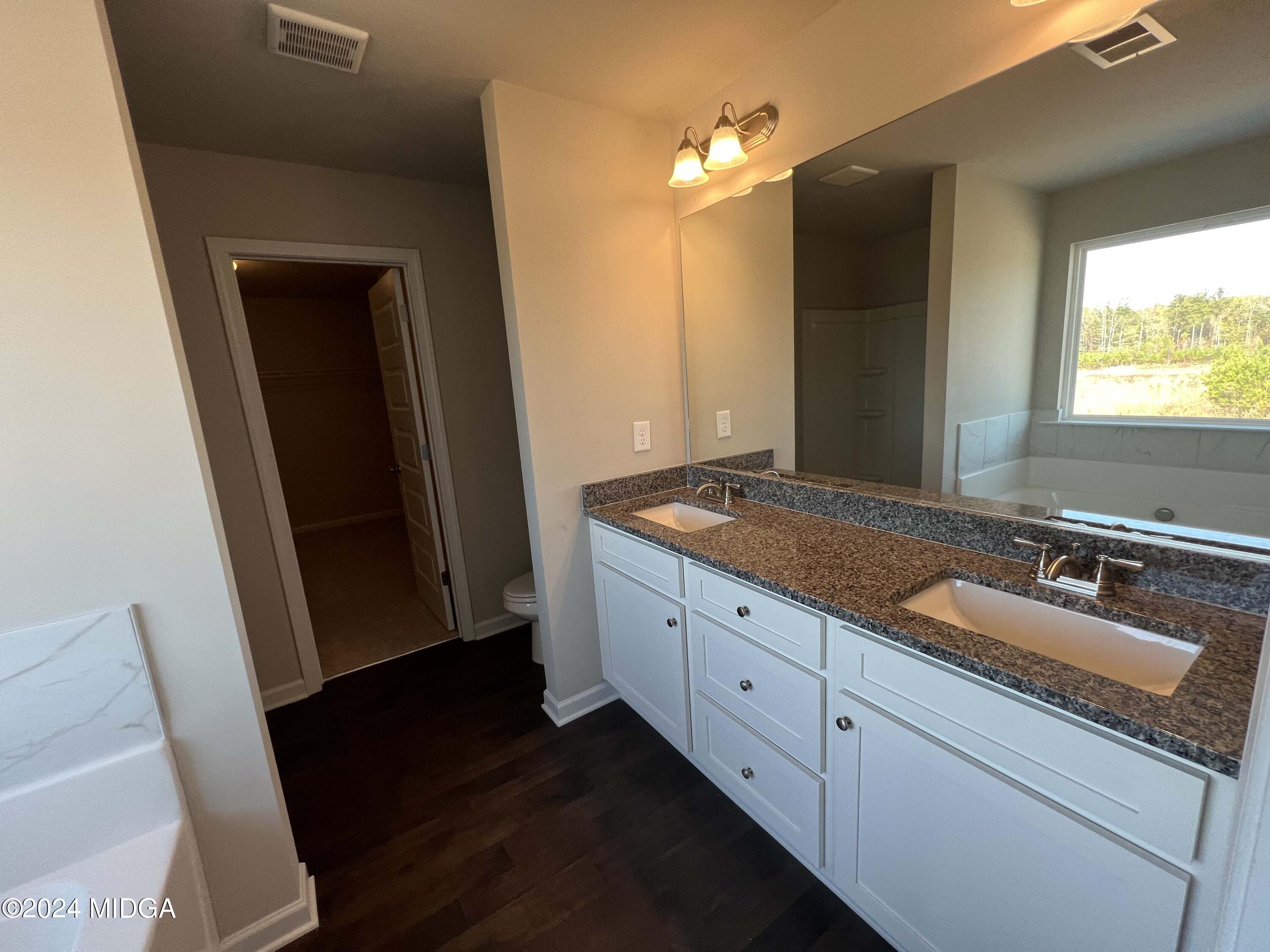 183 Sanders Road Macon, GA 31210 - Photo 26 of 44 a bathroom with a double vanity sink and mirror
