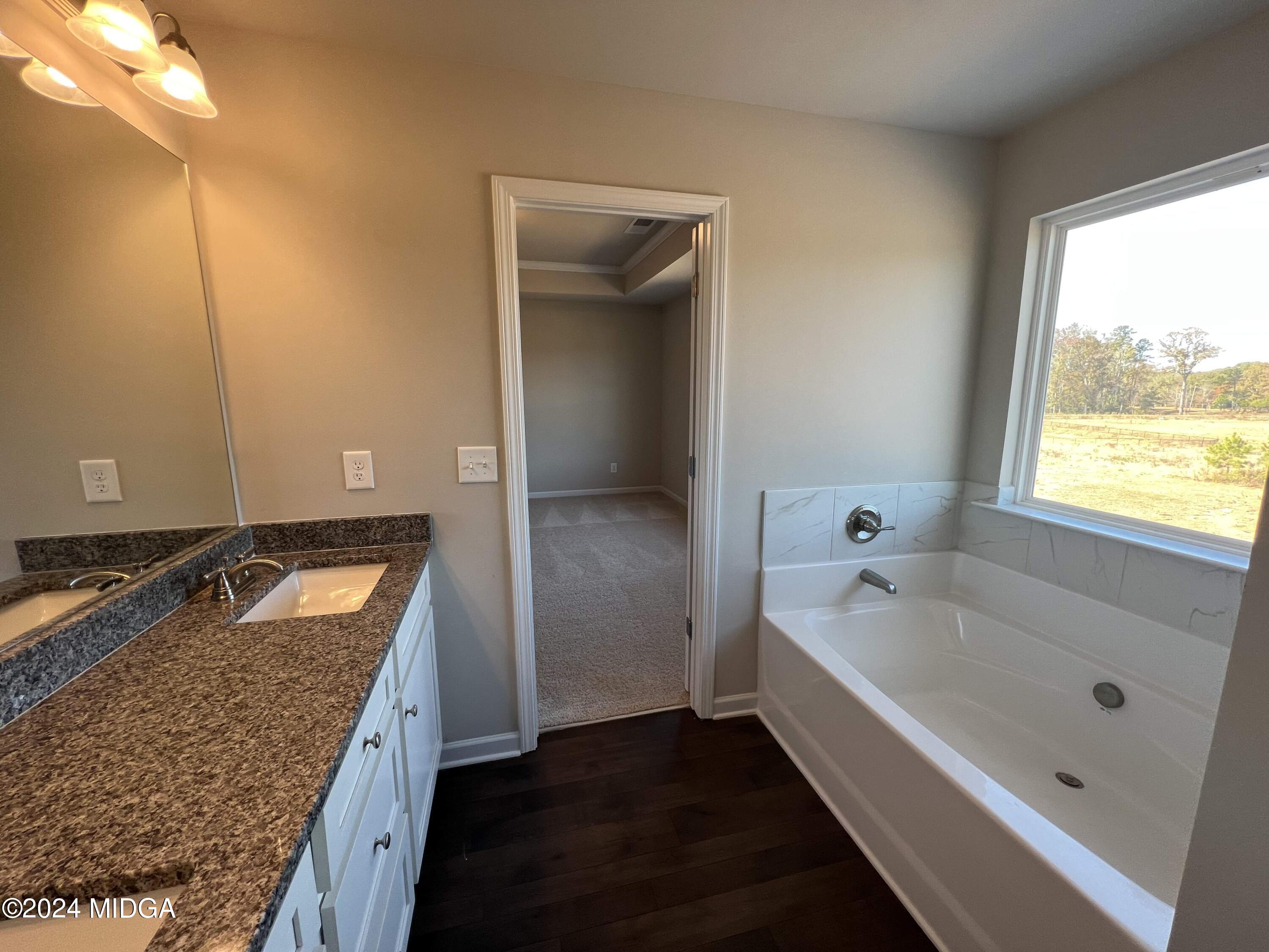 183 Sanders Road Macon, GA 31210 - Photo 28 of 44 a bathroom with a tub sink and mirror