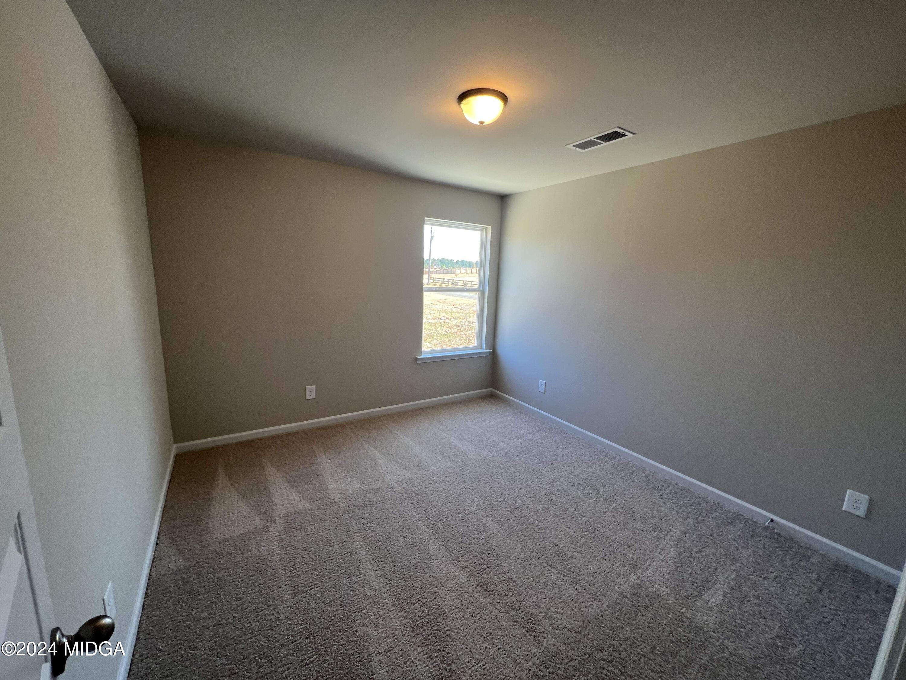 183 Sanders Road Macon, GA 31210 - Photo 31 of 44 an empty room with windows and closet in a room