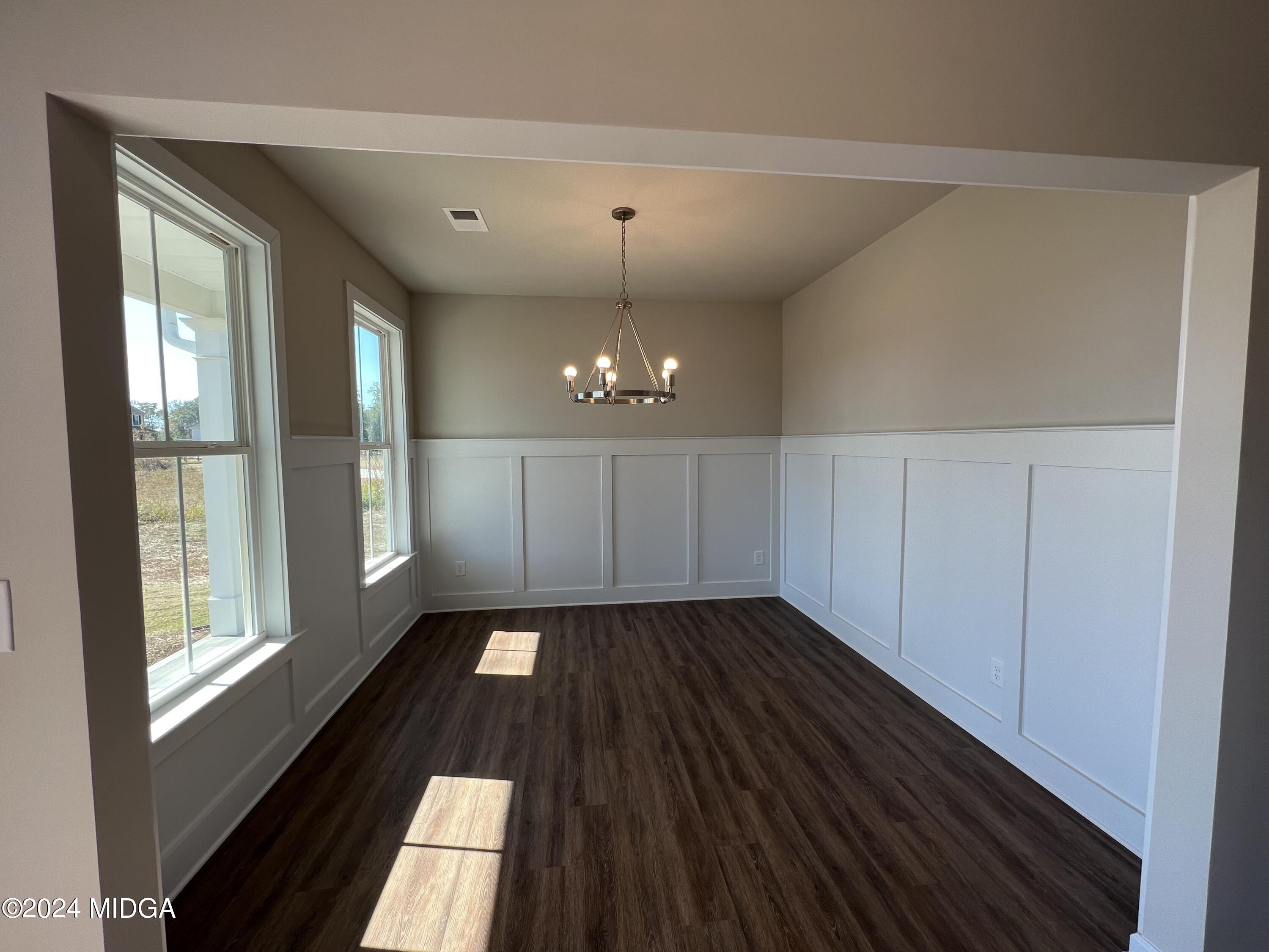 183 Sanders Road Macon, GA 31210 - Photo 4 of 44 a view of an empty room with glass door and windows