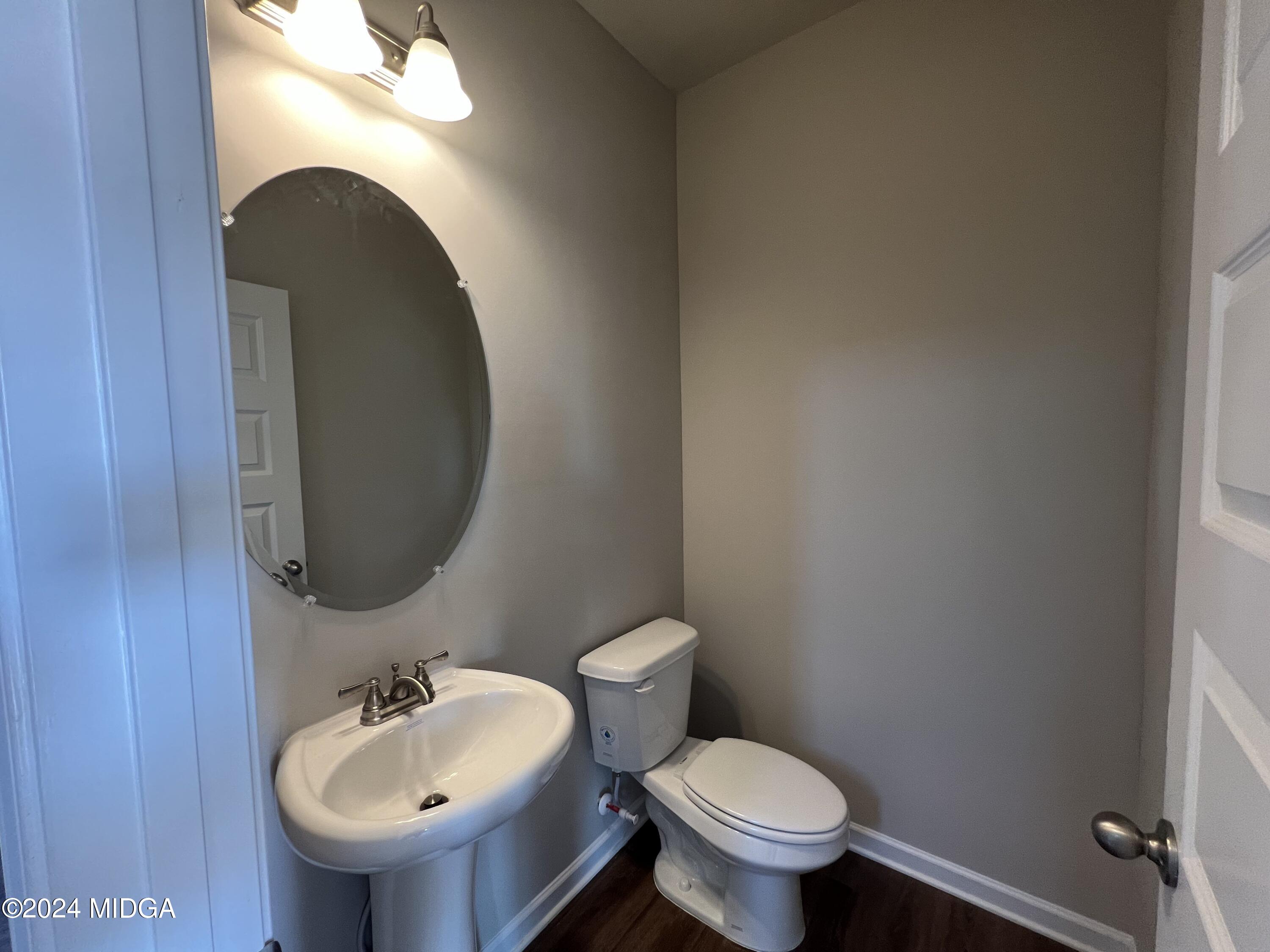 183 Sanders Road Macon, GA 31210 - Photo 7 of 44 a bathroom with a toilet sink and mirror