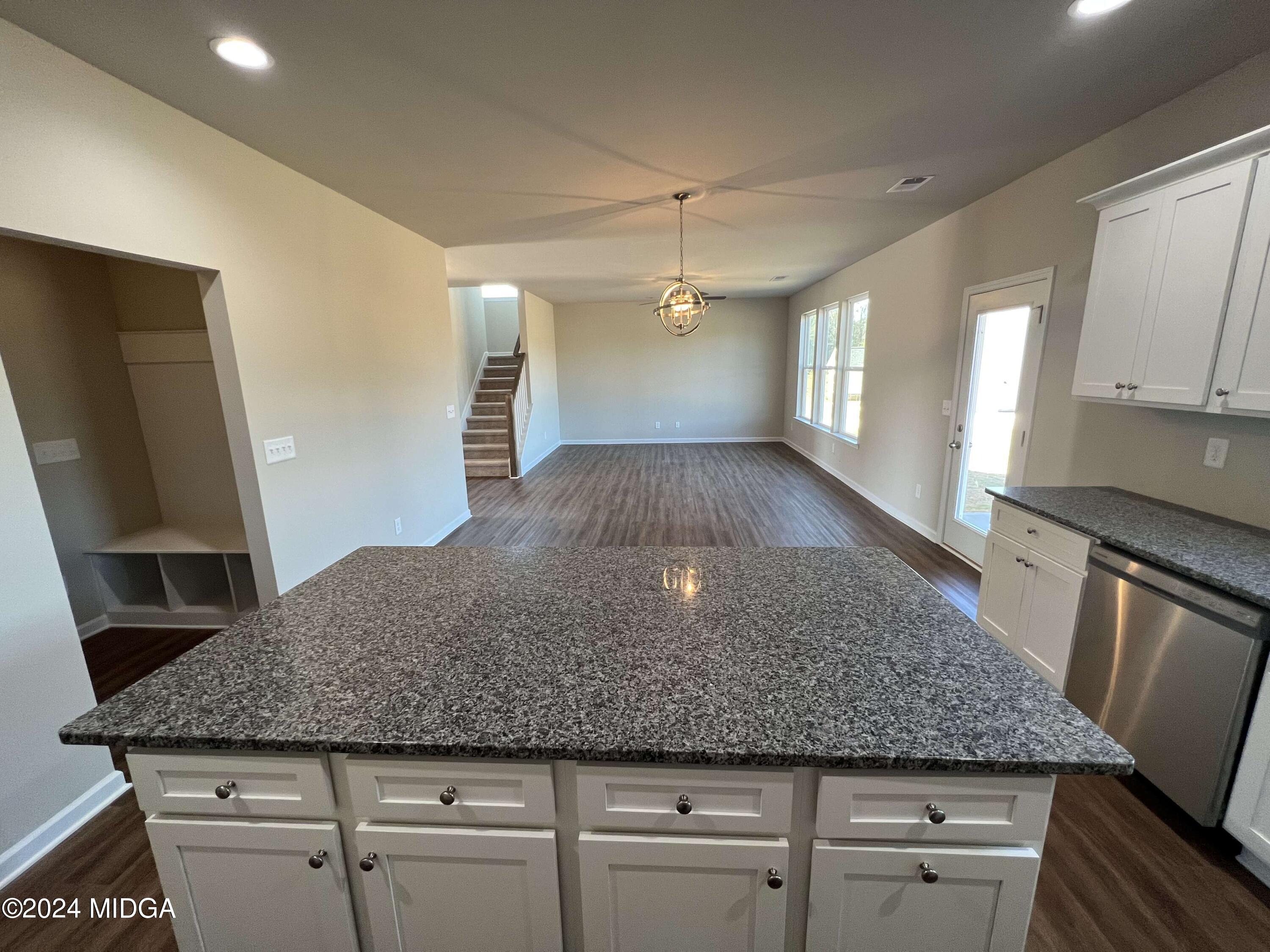 183 Sanders Road Macon, GA 31210 - Photo 9 of 44 a kitchen with granite countertop a sink a stove and refrigerator