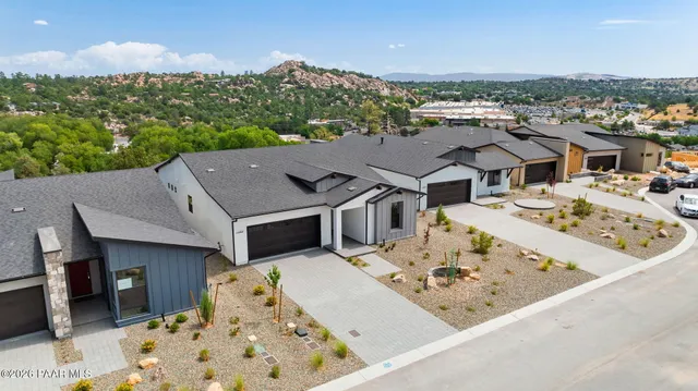 an aerial view of a house with a garden and lake view