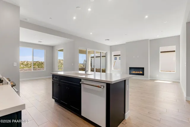 a kitchen with granite countertop a sink and cabinets