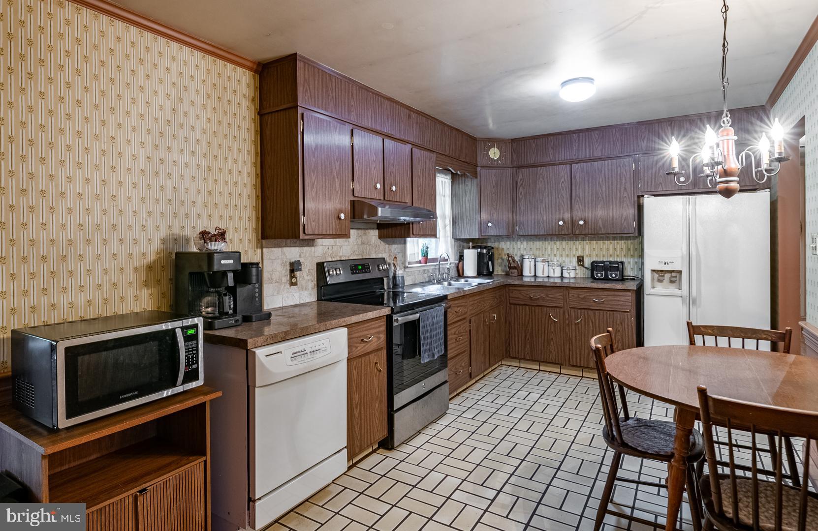 207 Laurel Avenue Hamburg, PA 19526 - Photo 7 of 25 a kitchen with a sink a counter top space and stainless steel appliances