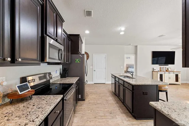 a living room with furniture and kitchen view