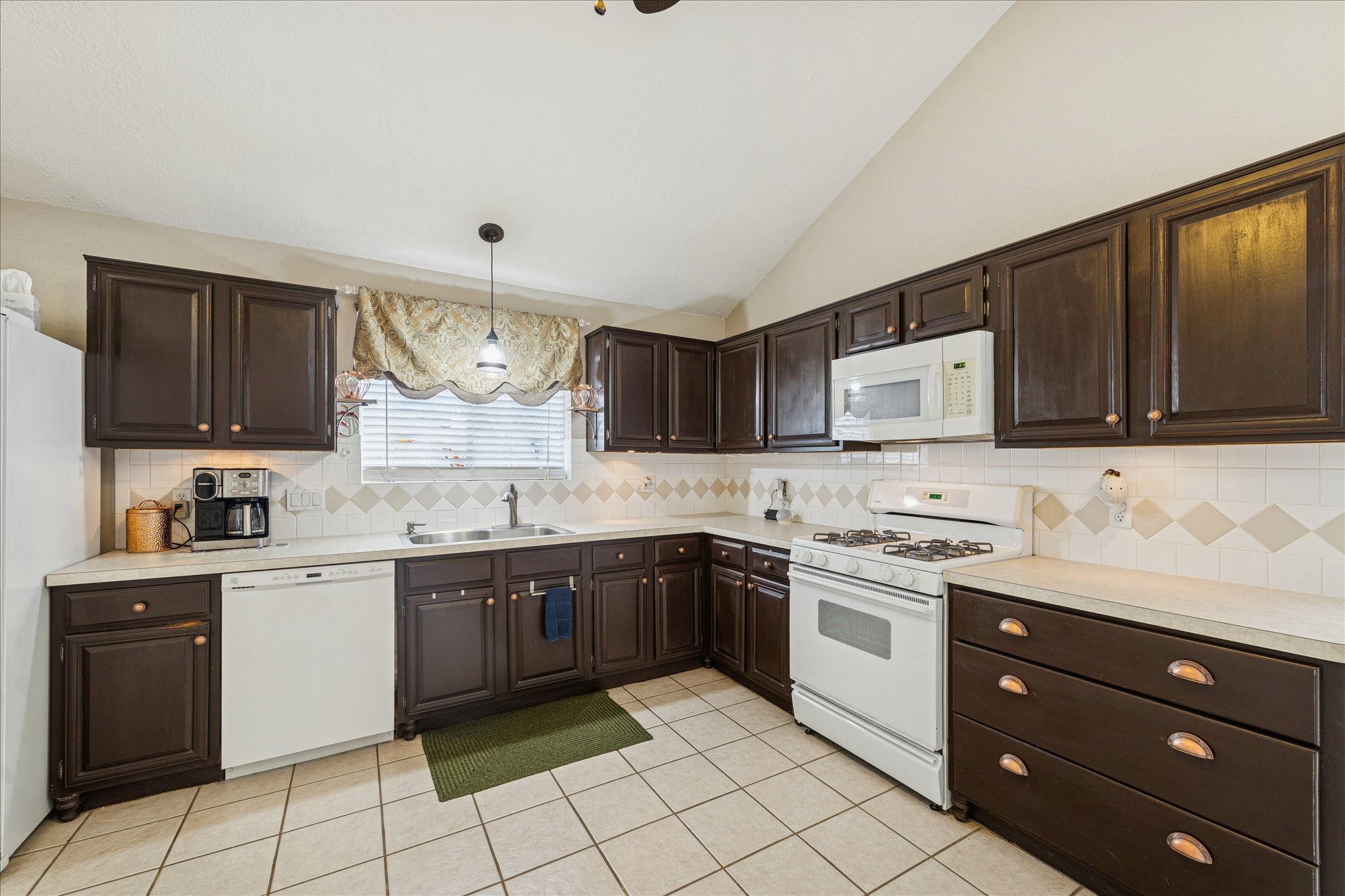 24919 Bovington Drive Spring, TX 77389 - Photo 5 of 21 The kitchen offers ample cabinet space with a gas range and refrigerator.