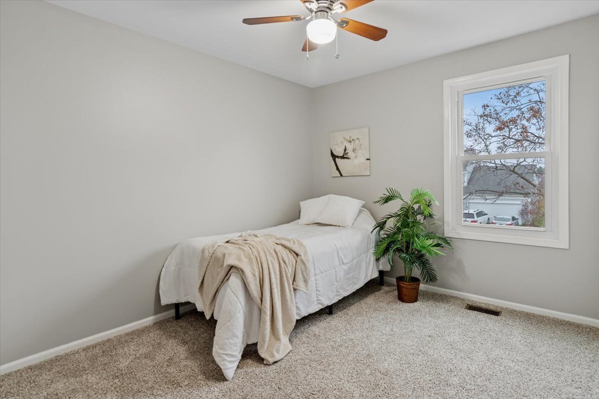 3131 Portland Court Aurora, IL 60504 - Photo 14 of 20 a bed sitting in a room next to a window