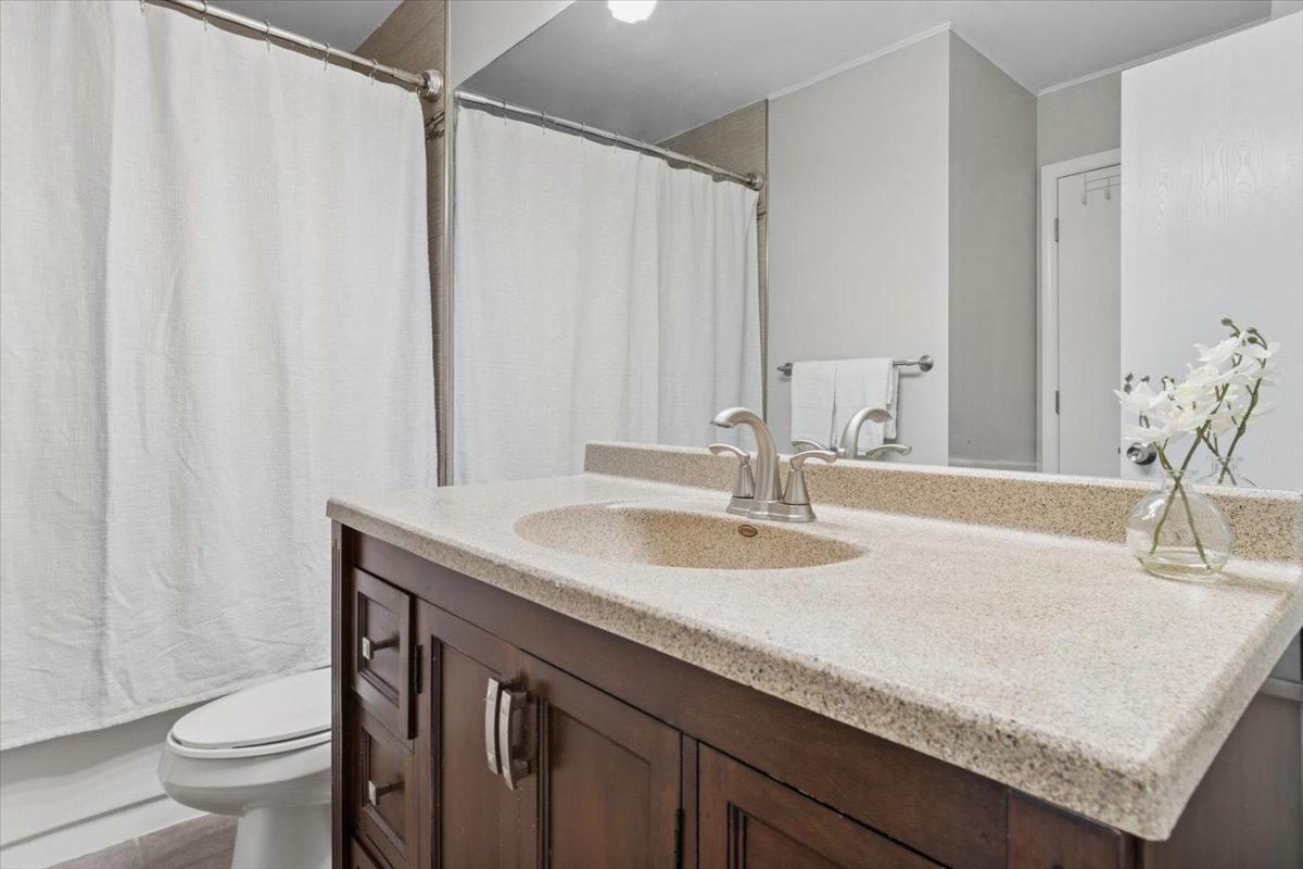 3131 Portland Court Aurora, IL 60504 - Photo 16 of 20 a bathroom with a granite countertop sink and a mirror