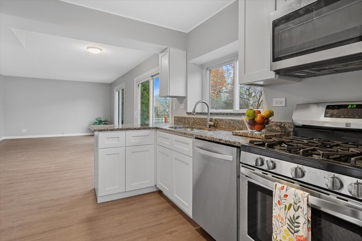 3131 Portland Court Aurora, IL 60504 - Photo 8 of 20 a kitchen with stainless steel appliances a sink stove and cabinets