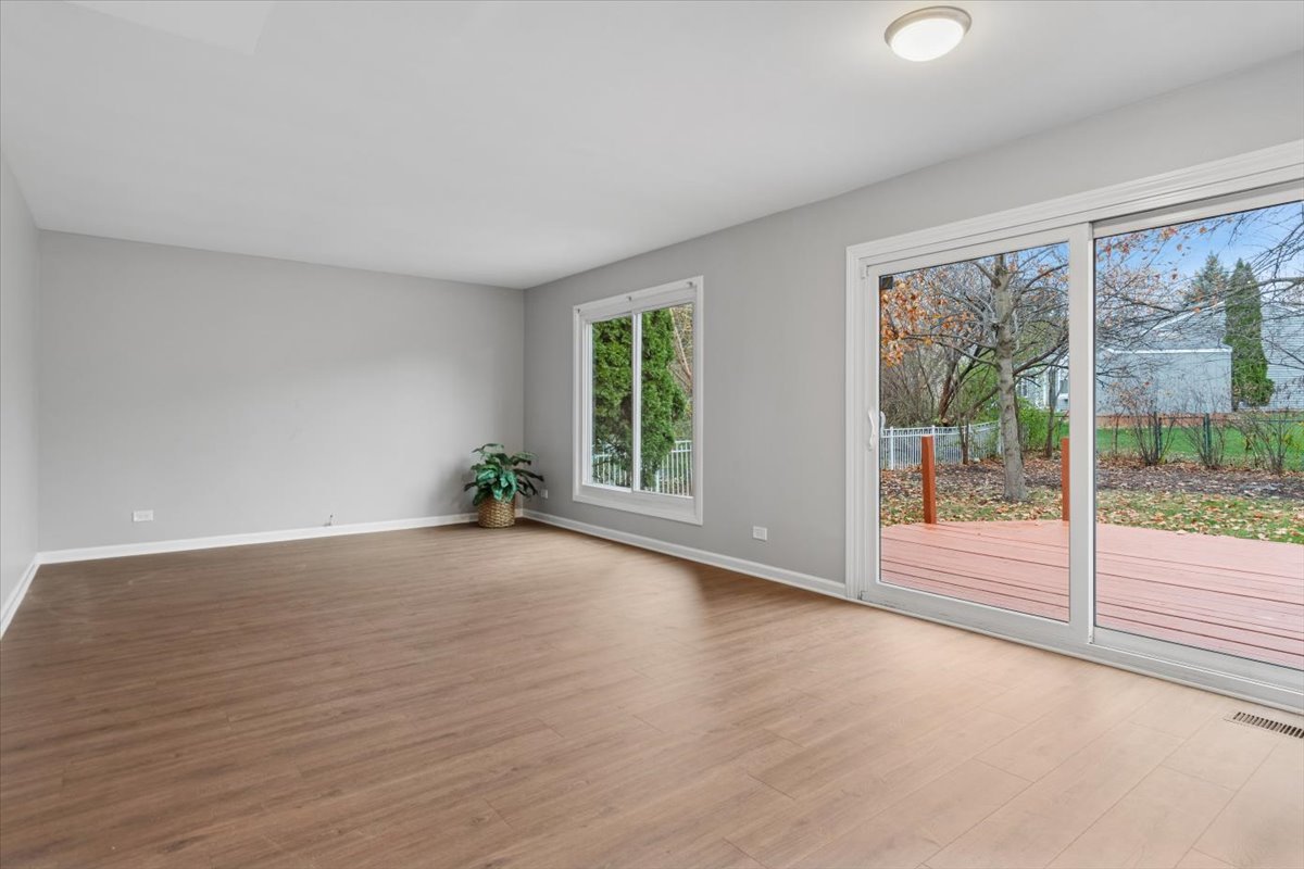 3131 Portland Court Aurora, IL 60504 - Photo 9 of 20 a view of a big room with wooden floor and windows