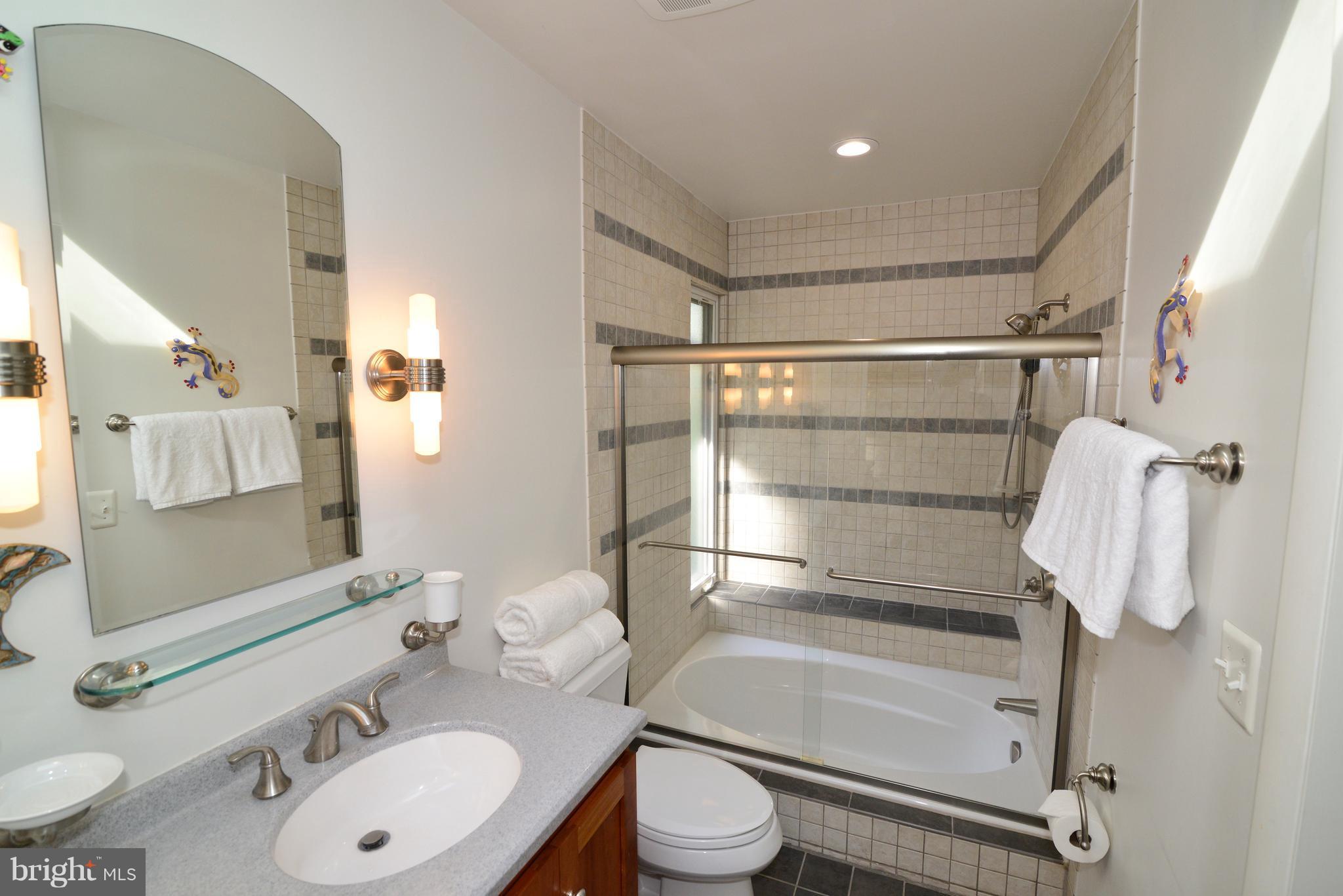 11303 South Shore Road Reston, VA 20190 - Photo 16 of 30 a bathroom with a sink toilet and shower