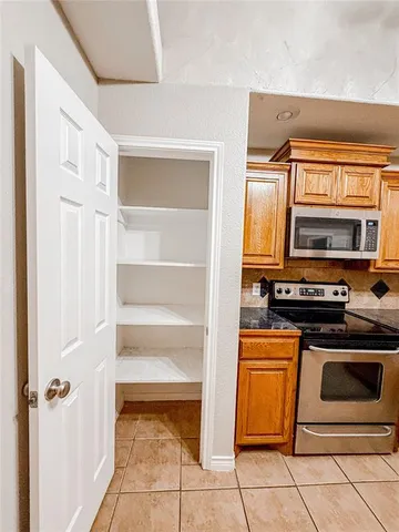 a kitchen with a stove and a microwave